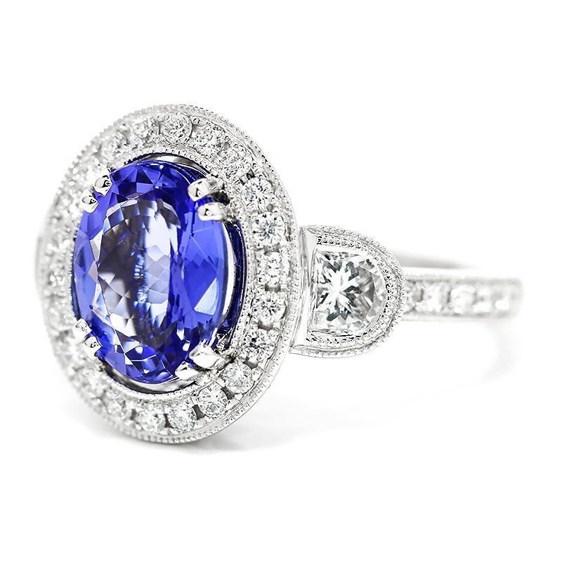 Once Upon A Diamond Ring Oval Tanzanite Halo Ring with Half Moon Diamond’s 18K