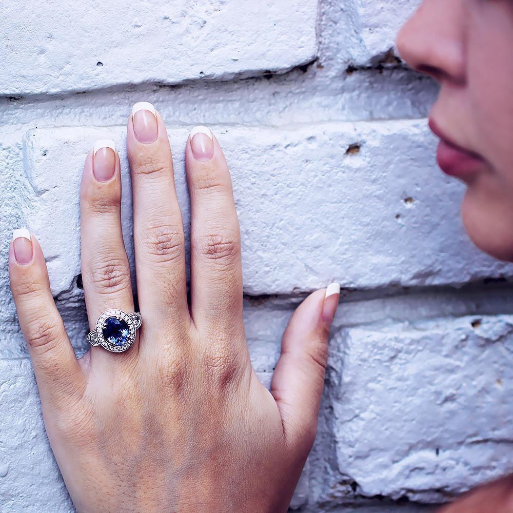 Once Upon A Diamond Ring Oval Tanzanite Halo Ring with Half Moon Diamond’s 18K